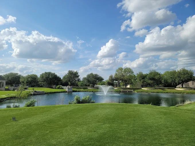 Scenic pond with a fountain at The Golf Club at Shadow Creek in Pflugerville, TX.